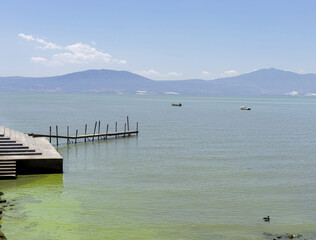 Concept dock and boats on the lake.