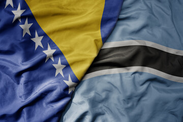 Fototapeta premium big waving national colorful flag of botswana and national flag of bosnia and herzegovina.