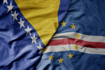 big waving national colorful flag of cape verde and national flag of bosnia and herzegovina.