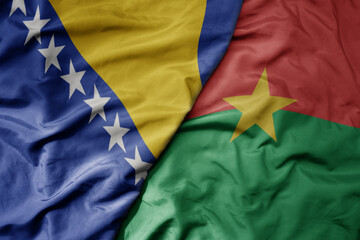 big waving national colorful flag of burkina faso and national flag of bosnia and herzegovina.