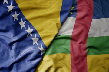 big waving national colorful flag of central african republic and national flag of bosnia and...
