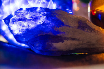 Transparent crystal in glowing blue light with orange in background