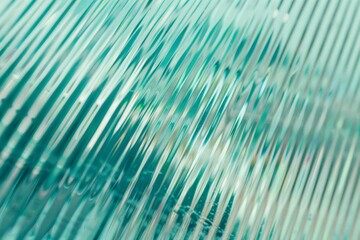 Abstract wave glass vertical line pattern background. Texture of wavy glass illuminated with light.