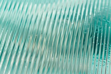 Abstract wave glass vertical line pattern background. Texture of wavy glass illuminated with light.