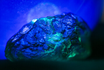 Close up texture detail on Moldavite rock in blue light
