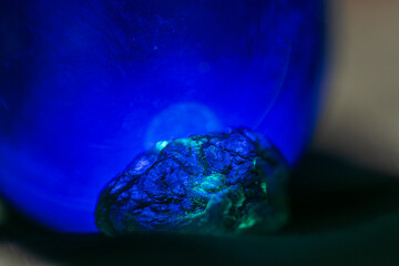 Moldavite crystal in blue turquoise light 