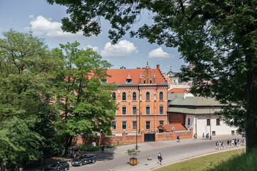 Fototapeta na wymiar Historical Tenement Overlooking Bustling Krakow Street
