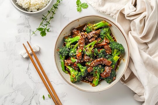 Delicious lunch Chinese beef stir fry with black pepper broccoli rice and white cloth