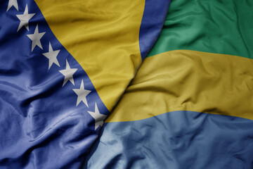 big waving national colorful flag of gabon and national flag of bosnia and herzegovina.