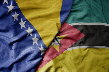 big waving national colorful flag of mozambique and national flag of bosnia and herzegovina.