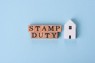 The inscription Stamp Duty made of wooden cubes on a plain background
