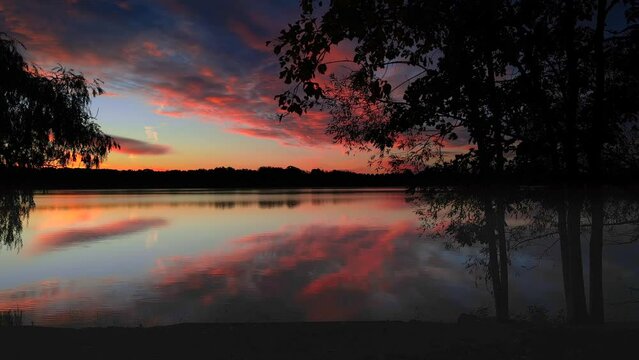 Exceptionally beautiful predawn sky reflected in still river waters
