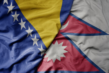 big waving national colorful flag of nepal and national flag of bosnia and herzegovina.