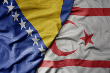 big waving national colorful flag of northern cyprus and national flag of bosnia and herzegovina.