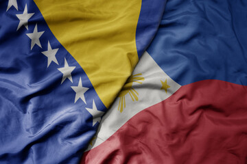 big waving national colorful flag of philippines and national flag of bosnia and herzegovina.