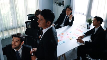 Top view of businessman explain marketing strategy and choose idea by using colorful stick notes....