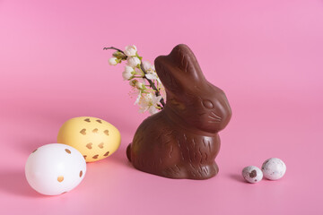 Chocolate rabbit symbol to Easter holidays on a pink background