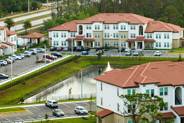 Aerial view of american apartment buildings in Florida residential area. New family condos as example of housing development in US suburbs