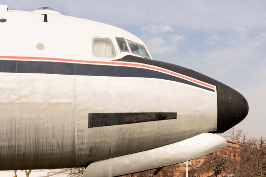 Close-up image capturing the iconic nose and cockpit windows of a vintage airliner, showcasing the timeless design of classic aviation