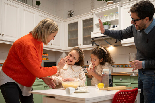 Joyful family cooking together in a cozy home kitchen