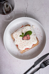 Belgian waffles with strawberry confit and cream sauce on grey background