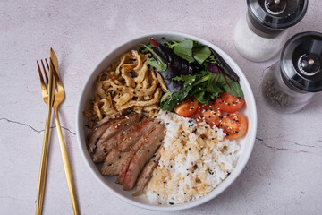 Bowl with rice, veal and vegetables. Balanced nutrition concept.