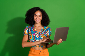 Obrazy na Plexi  Photo of trainee specialist young woman working in it corporation develop new soft using laptop isolated over green color background