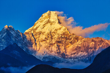 Resplendent Ama Dablam is bathed in the golden light of a scenic Himalayan sunset as seen from the scenic village of Pangboche in the upper Khumbu, Nepal