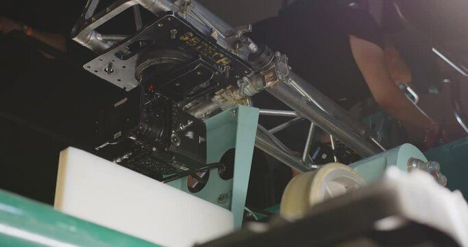 A movie camera mounted on a roller coaster cart.