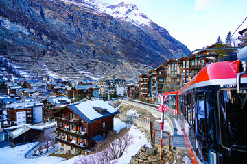 Cogwheel train of the Gornergrat Railway arriving in Zermatt in the Swiss Alps in winter, Canton of...