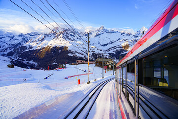 View of the snow-capped mountains from a window of the cogwheel train of the Gornergrat Railway...
