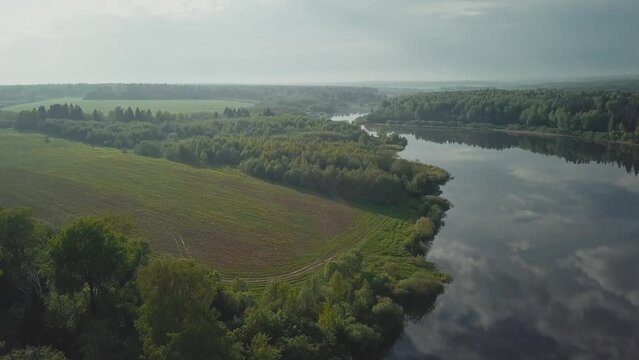 A beautiful cinematic frame of nature. A picture of a small river among fields