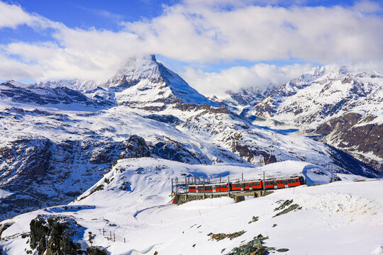 Cogwheel train of the Gornergrat Railway climbing the mountain facing the Matterhorn above Zermatt in the Swiss Alps in winter, Canton of Valais, Switzerland