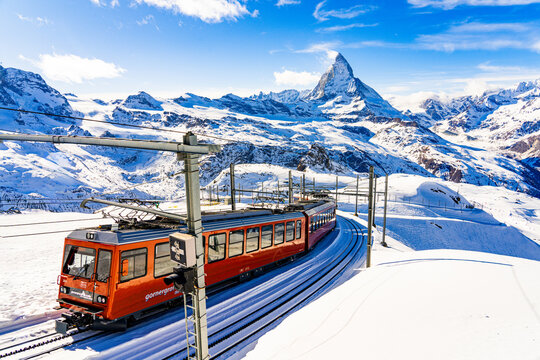 Cogwheel train of the Gornergrat Railway climbing the mountain facing the Matterhorn above Zermatt in the Swiss Alps in winter, Canton of Valais, Switzerland
