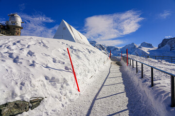 Snow-covered pathway near the Gornergrat Observatory housed in the building of the Kulmhotel facing the Matterhorn in the Pennine Alps, Canton of Valais, Switzerland