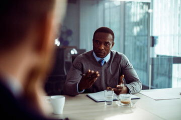 Businessman in meeting with professionals in modern office