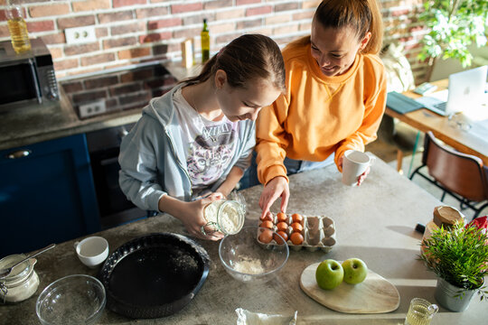 Mother and daughter baking together at home