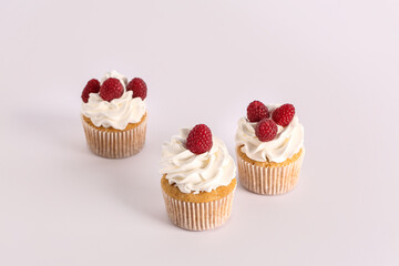 Tasty raspberry cupcakes on grey background