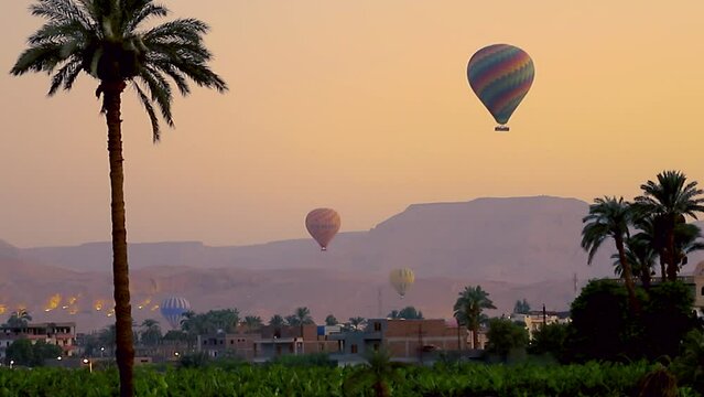 July 6, 2021 - West Bank, Luxor Egypt. Time lapse of the very slow and delicate process of the hot air balloons taking off at the break of dawn.