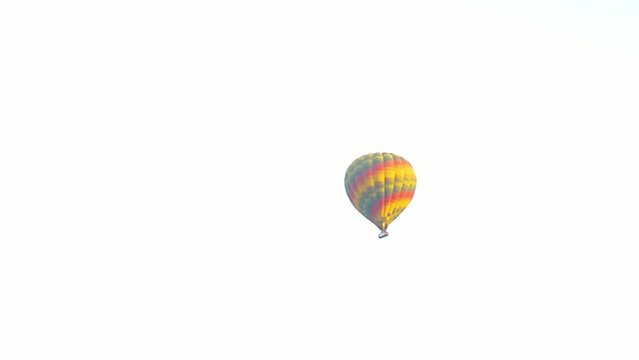 July 6, 2021 - West Bank, Luxor Egypt. Hot air balloons taking off at dawns first light and lofting their way across valley of the kings and other famous archeological sites.
