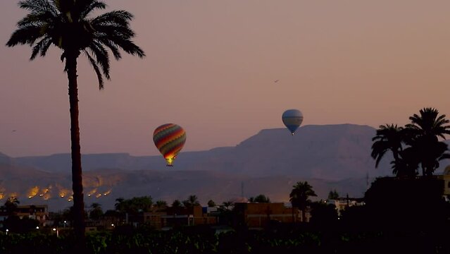 July 6, 2021 - West Bank, Luxor Egypt. Time lapse of the very slow and delicate process of the hot air balloons taking off at the break of dawn.