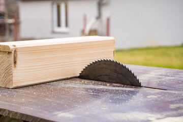 Closeup of wood cutting table with electric circular saw. Construction concept.