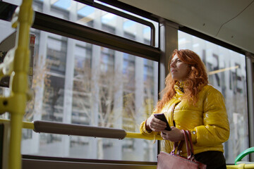 woman stand up inside the bus