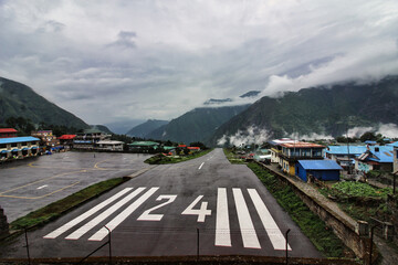 Lukla Airport runway on a rain soaked day - the weather conditions add to the danger of taking off...