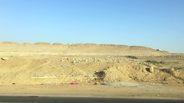 May 24, 2021 - Giza, Cairo Egypt. The full length from back to front of the Giza Plateau as it runs parallel with the highway.