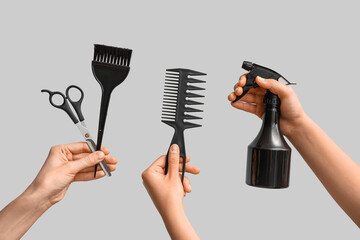 Female hands with hair supplies on white background.