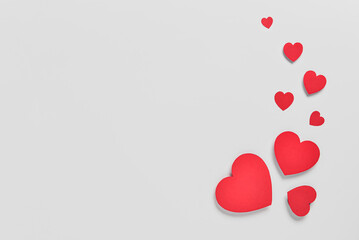 Romantic composition with red paper hearts on white background. St. Valentine's Day. - obrazy, fototapety, plakaty