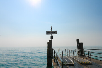 Landing bridge in Bardolino, Lake Garda, Italy, where the tourist ferries board and onboard...