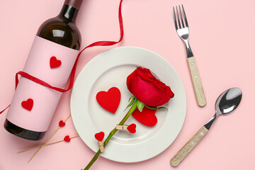 Beautiful table setting with ribbon and red rose on pink background. Valentine's Day celebration