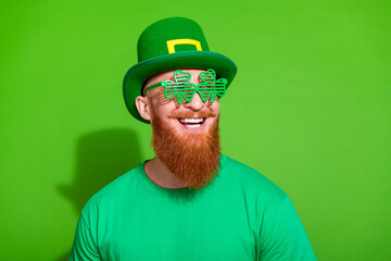 Photo of extravagant positive person shamrock shape glasses empty space ad isolated on green color...